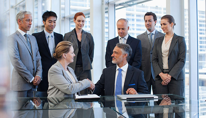 Corporate gifting handshake in a boardroom